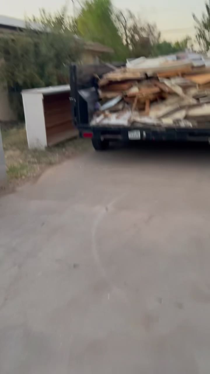 Dump trailer fully loaded with demo debris